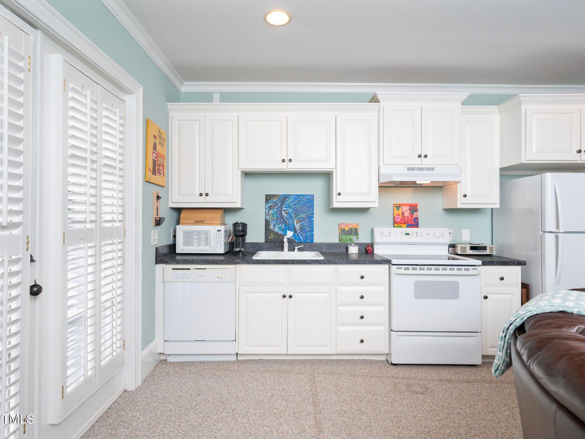 2512 Lewiswood Lane Raleigh, NC 27608 - Photo 31 of 41 a kitchen with granite countertop white cabinets and white appliances