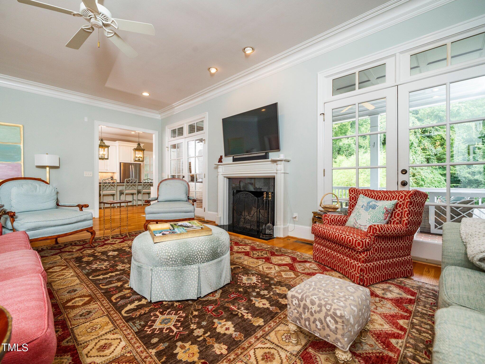 2512 Lewiswood Lane Raleigh, NC 27608 - Photo 4 of 41 a living room with furniture a flat screen tv and a fireplace