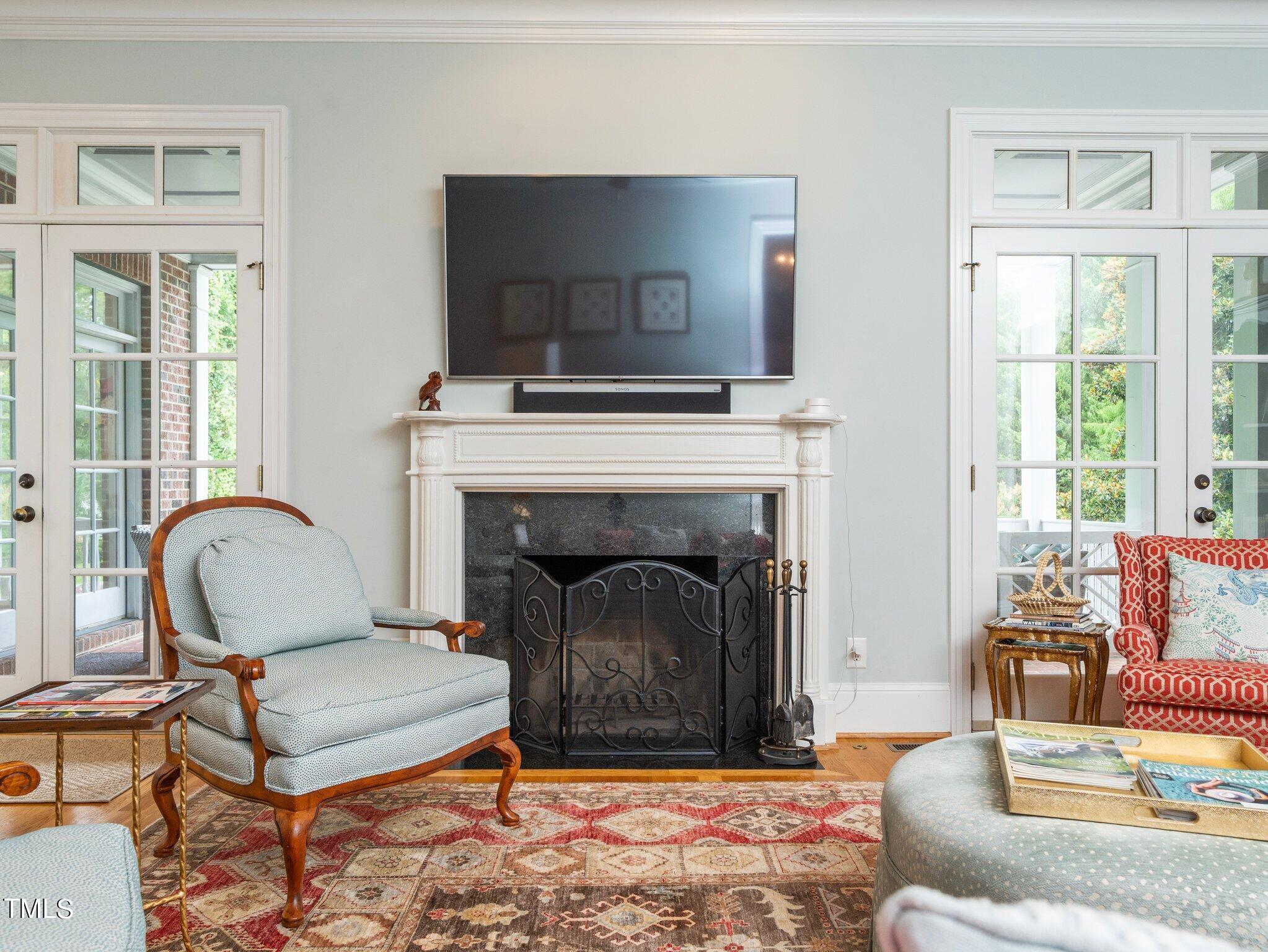 2512 Lewiswood Lane Raleigh, NC 27608 - Photo 6 of 41 a living room with furniture a flat screen tv and a fireplace