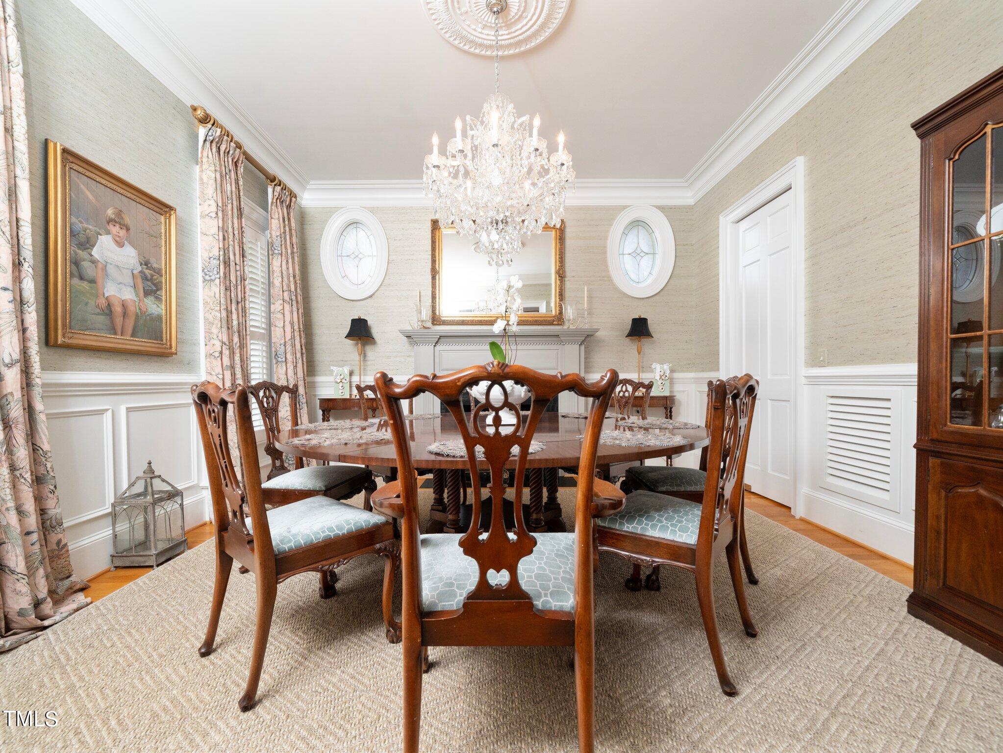 2512 Lewiswood Lane Raleigh, NC 27608 - Photo 10 of 41 a view of a dining room with furniture a chandelier and wooden floor