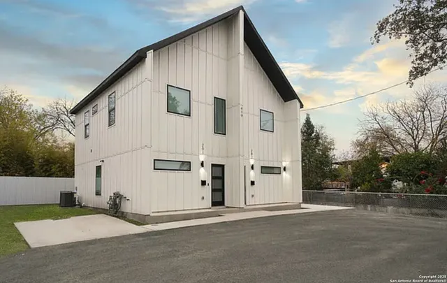 a view of a white house with a road