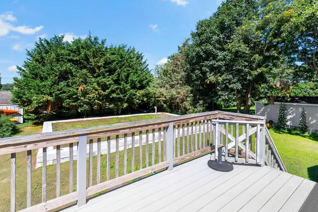 a view of balcony with wooden floor and fence