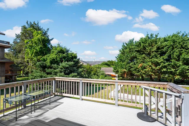 an aerial view of ocean and residential houses with outdoor space