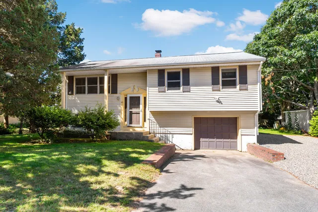 a spacious bedroom with a bed and wooden floor