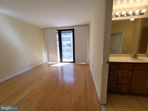a view of an empty room and wooden door