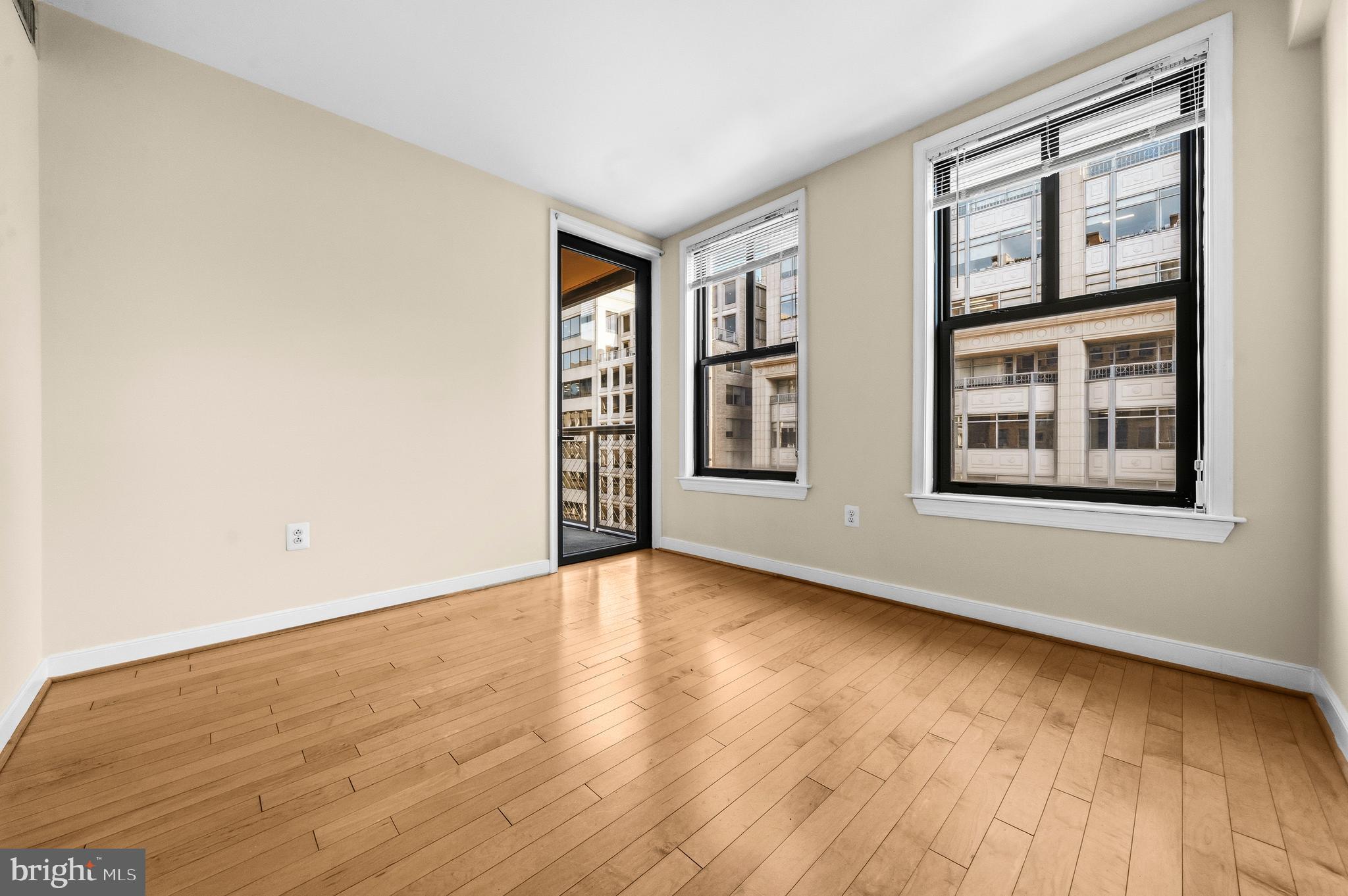 631 D Street Northwest, Unit 733 Washington, DC 20004 - Photo 18 of 100 an empty room with wooden floor and windows