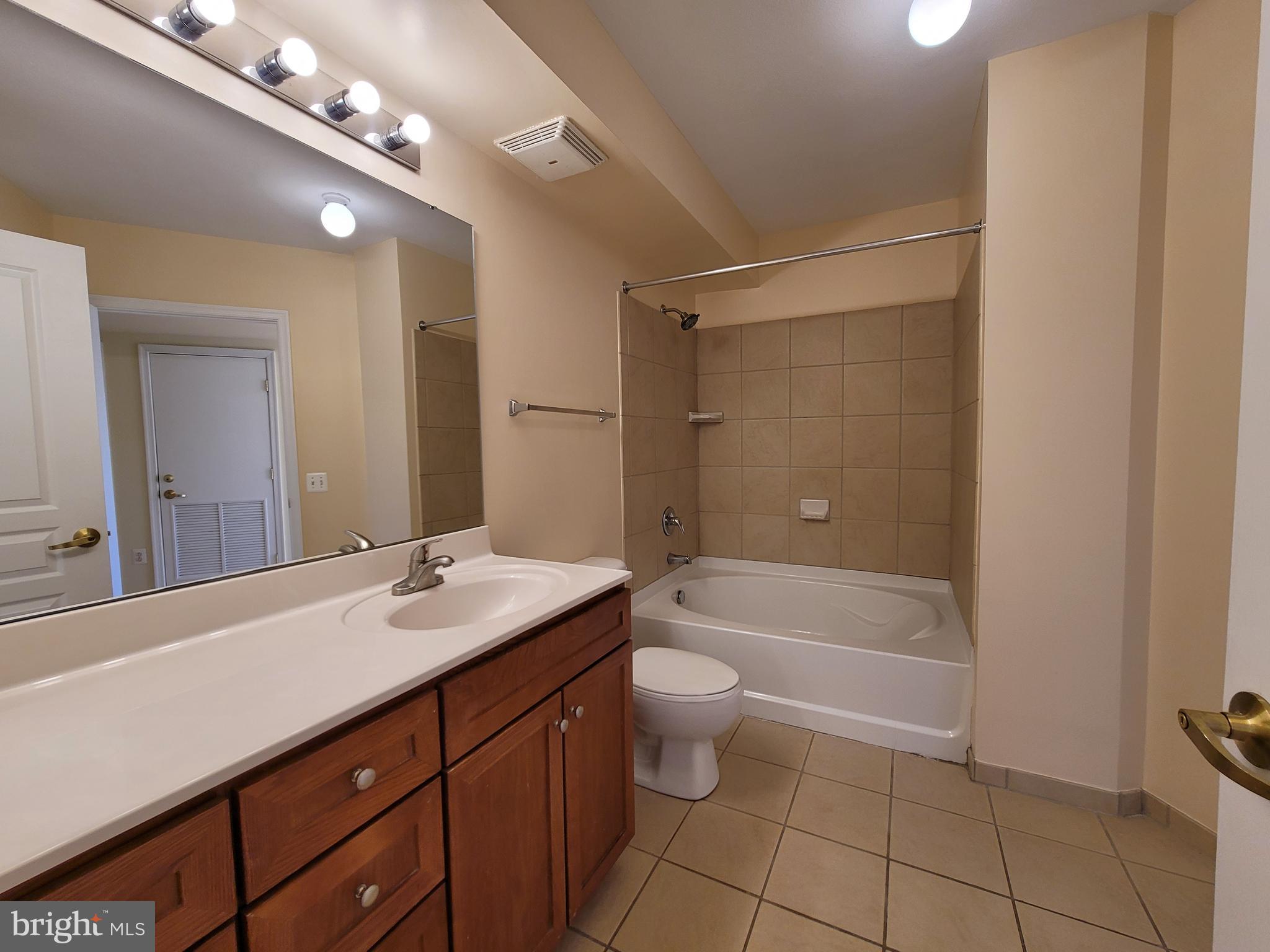 631 D Street Northwest, Unit 733 Washington, DC 20004 - Photo 19 of 87 a bathroom with a sink a toilet a large mirror and shower