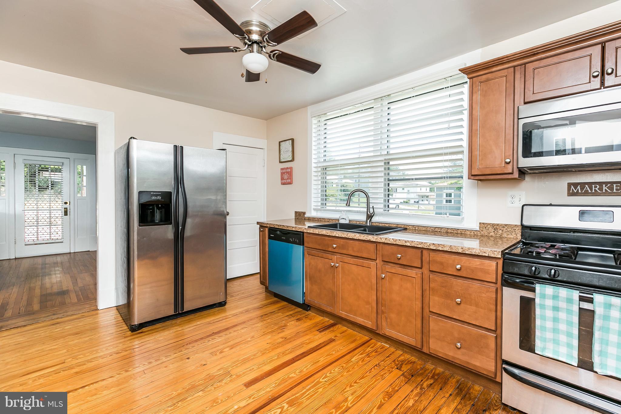 801 Woodsdale Road Baltimore, MD 21228 - Photo 10 of 29 Kitchen has ceiling fan, hardwood flooring