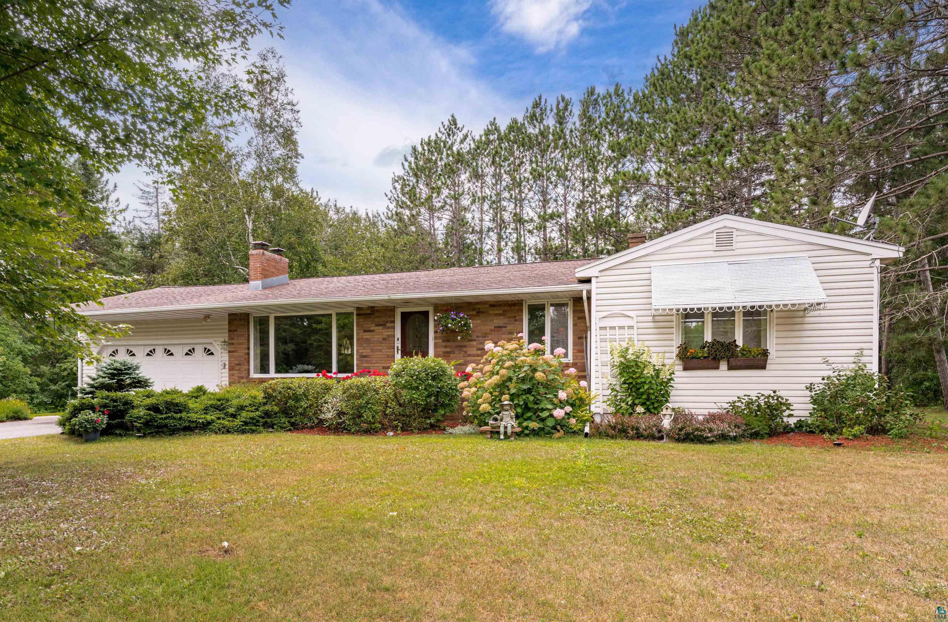 3727 Stebner Road Hermantown, MN 55811 - Photo 1 of 41 Brick and siding exterior with a pitched roof, attached garage, and mature landscaping