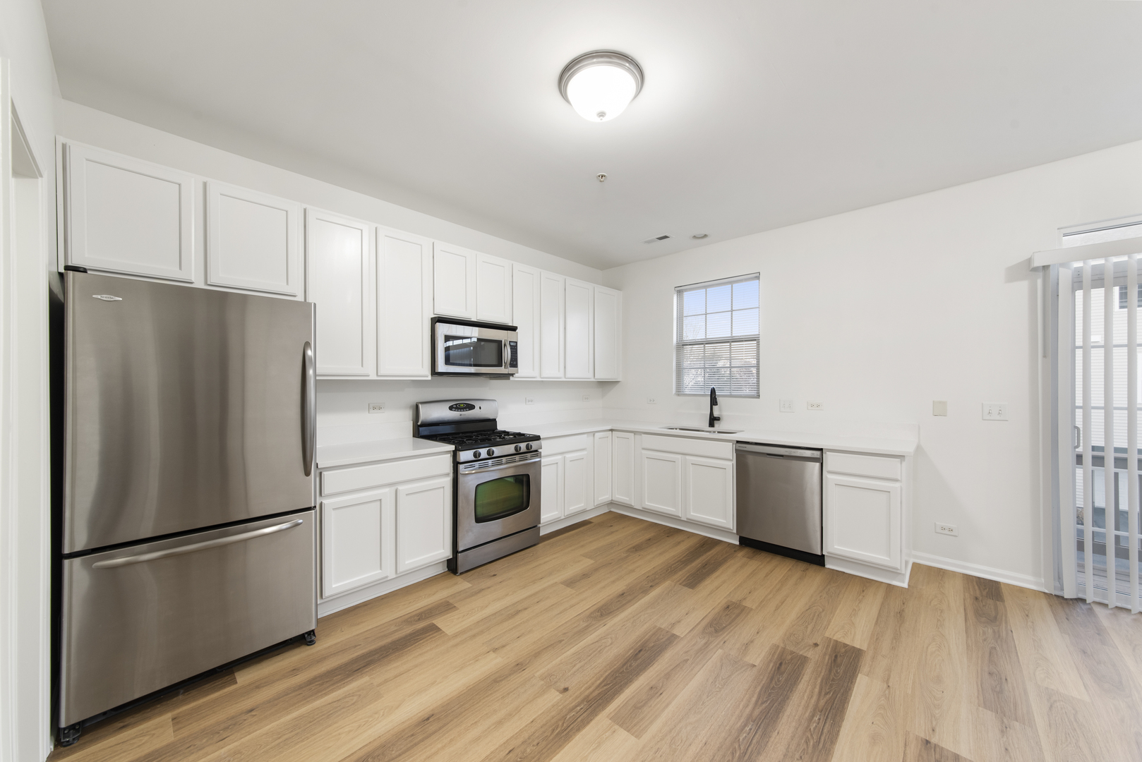 3721 Bailey Road Yorkville, IL 60560 - Photo 4 of 18 a kitchen with stainless steel appliances a refrigerator sink and microwave