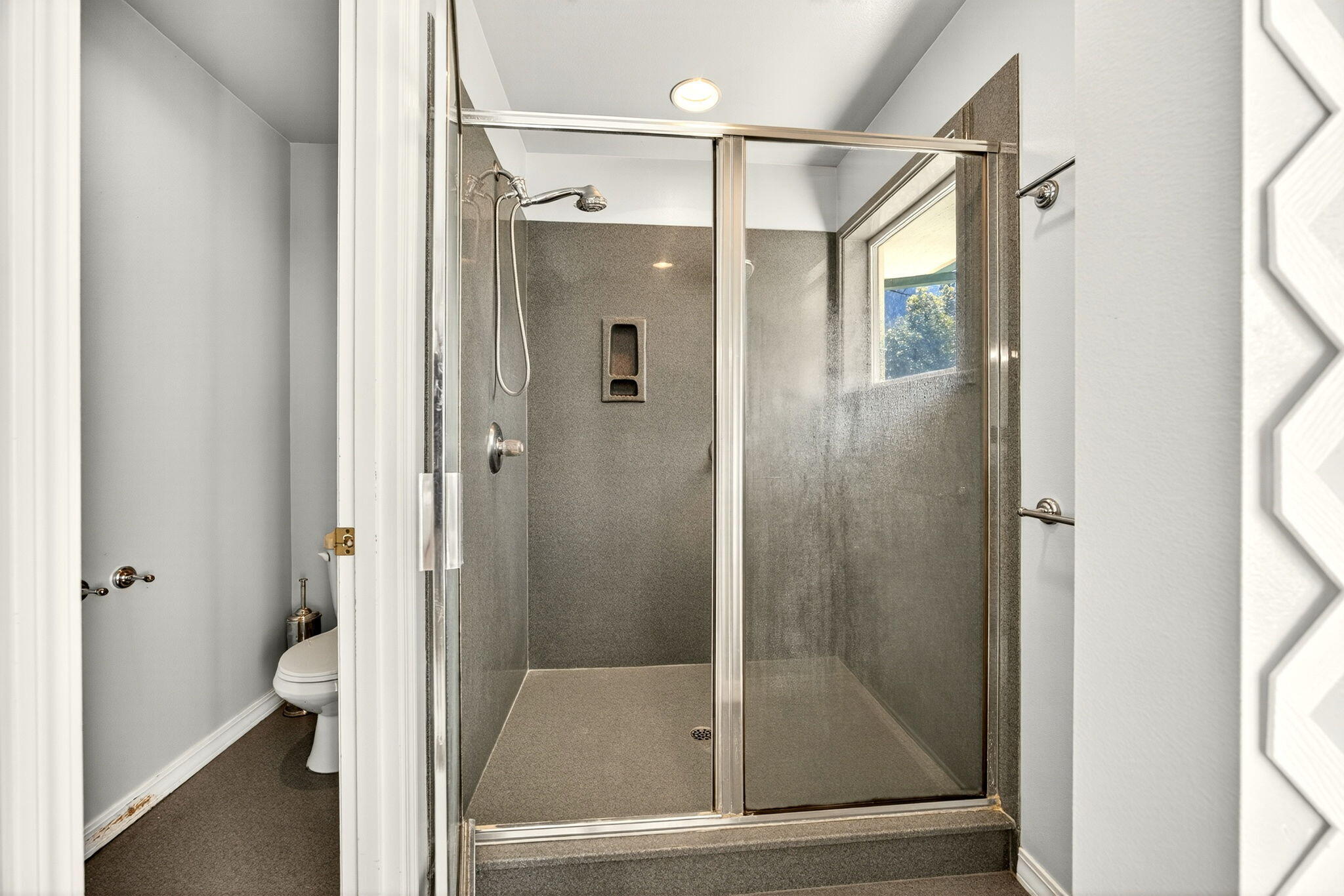 2467 Eastside Road Jacksonville, OR 97530 - Photo 75 of 85 a bathroom with a glass shower door and a glass door