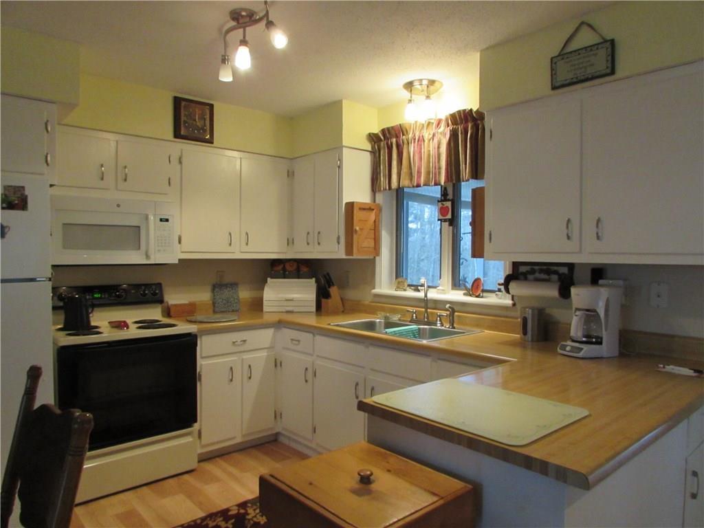 542 Upper E Pond Road Nobleboro, ME 04555 - Photo 5 of 22 Kitchen overlooks sunny backyard and...