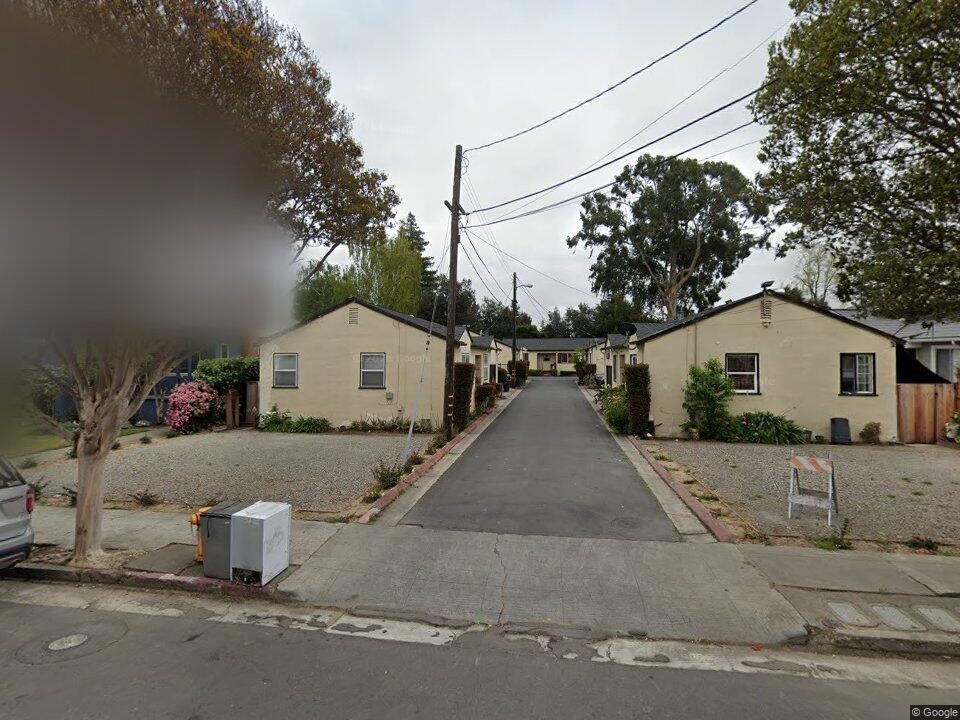View of front of house with a residential view and stucco siding