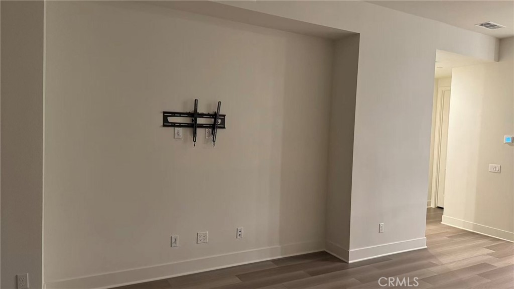 16432 Compass Avenue Tustin, CA 92782 - Photo 11 of 35 a view of a hallway with wooden floor