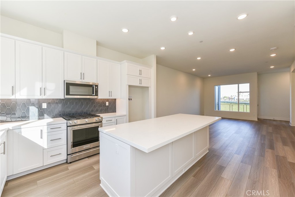 16432 Compass Avenue Tustin, CA 92782 - Photo 12 of 35 a kitchen with a stove a sink and a refrigerator