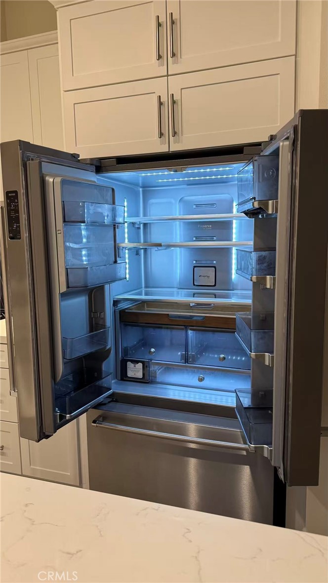 16432 Compass Avenue Tustin, CA 92782 - Photo 15 of 35 a living room with stainless steel appliances kitchen island granite countertop a refrigerator and a stove