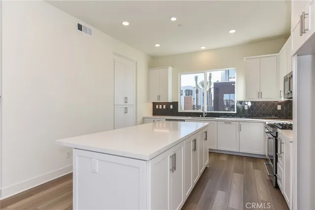 a kitchen with a sink and white cabinets