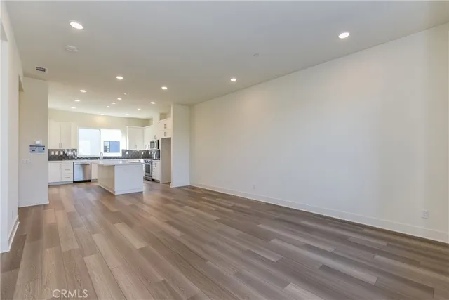 a view of kitchen with kitchen island and stainless steel appliances