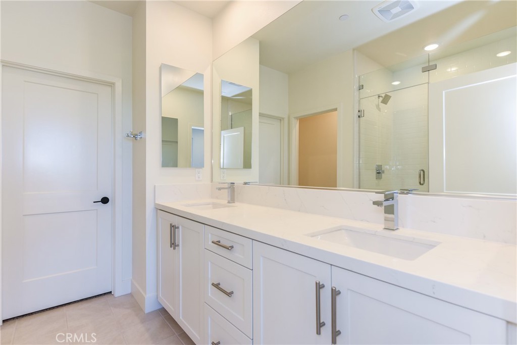 16432 Compass Avenue Tustin, CA 92782 - Photo 32 of 35 a bathroom with a sink double vanity and a mirror