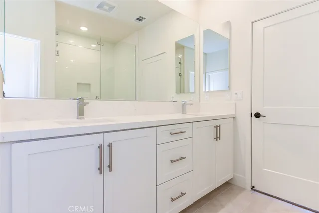 a view of a bathroom with a sink and a mirror