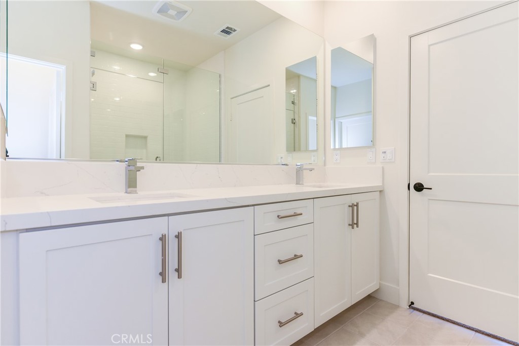 16432 Compass Avenue Tustin, CA 92782 - Photo 33 of 35 a bathroom with a sink and a mirror