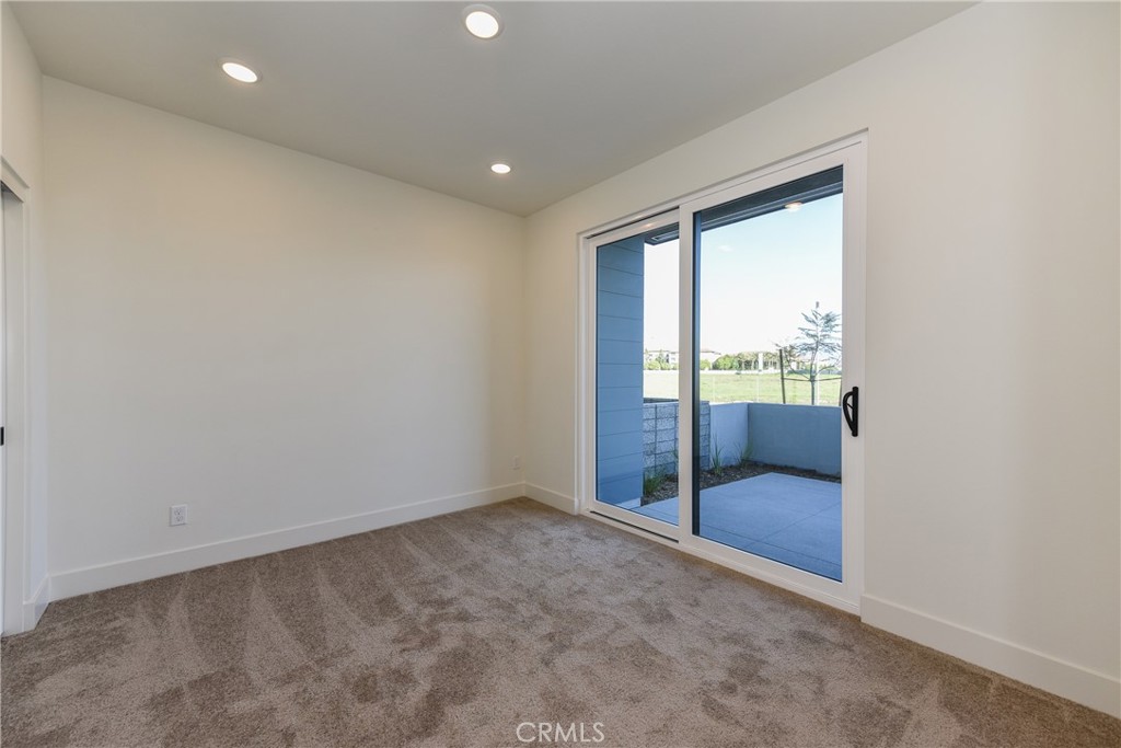 16432 Compass Avenue Tustin, CA 92782 - Photo 6 of 35 an empty room with sliding glass door and shower