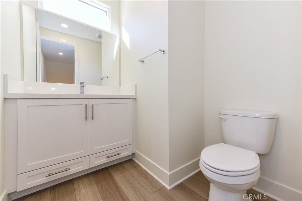 16432 Compass Avenue Tustin, CA 92782 - Photo 7 of 35 a bathroom with a sink a toilet and a mirror