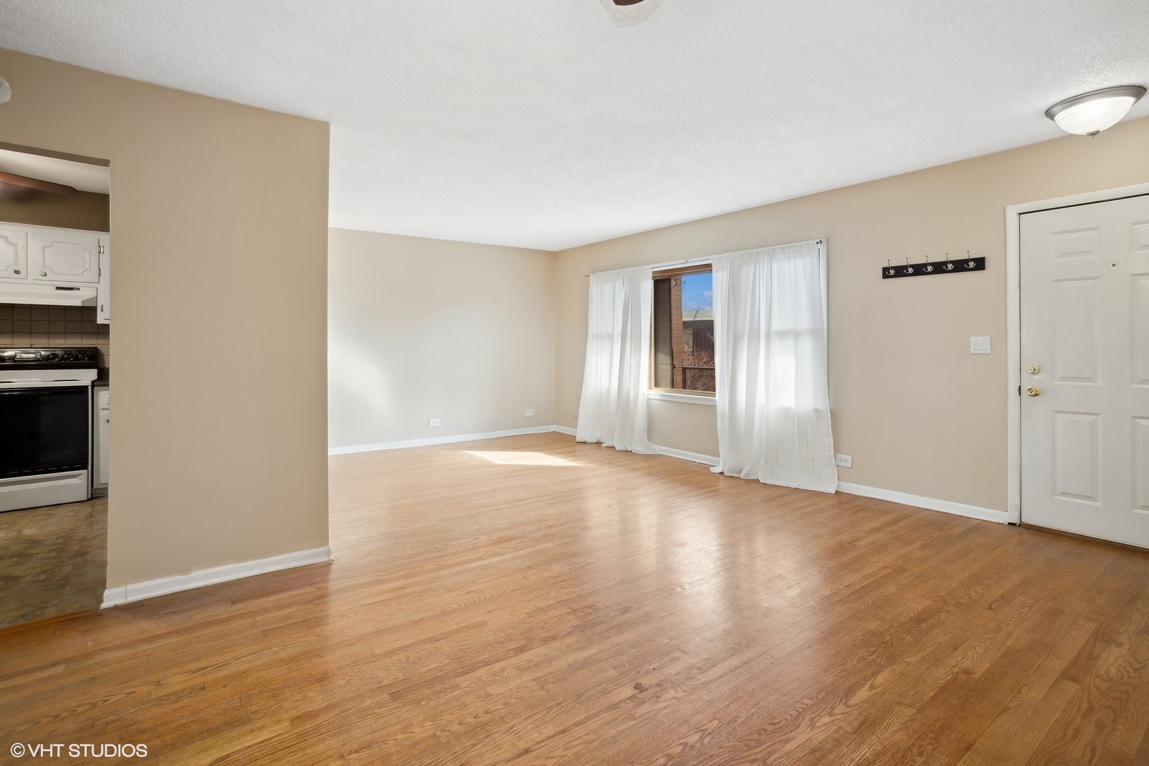 9624 West Higgins Road, Unit 3FN Rosemont, IL 60018 - Photo 3 of 12 an empty room with wooden floor & windows and bathroom