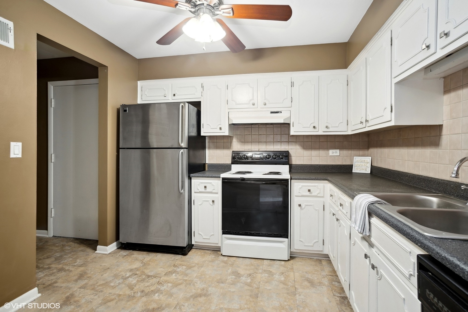 9624 West Higgins Road, Unit 3FN Rosemont, IL 60018 - Photo 4 of 12 a kitchen with a refrigerator sink and cabinets