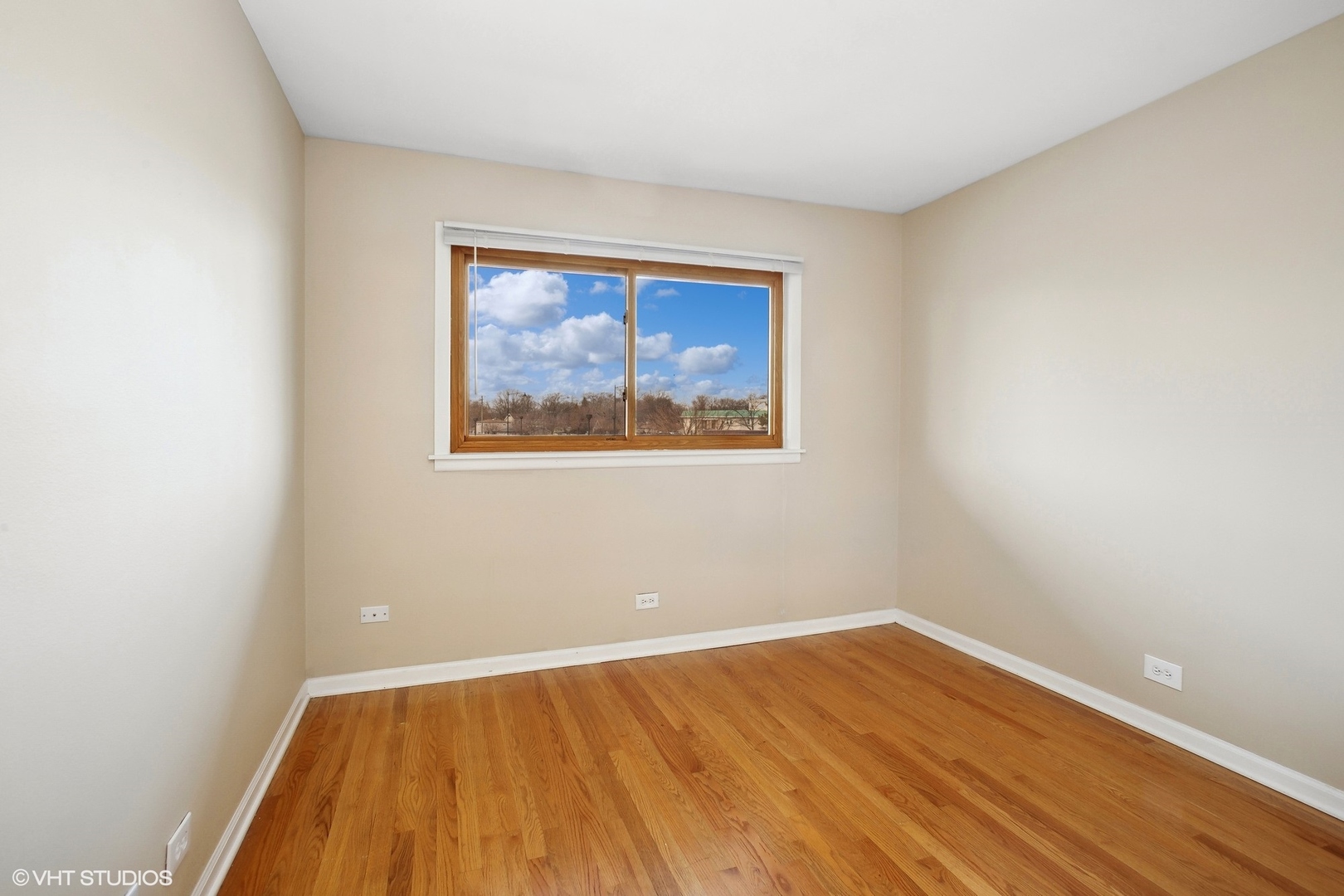 9624 West Higgins Road, Unit 3FN Rosemont, IL 60018 - Photo 7 of 12 a view of an empty room with wooden floor and a window