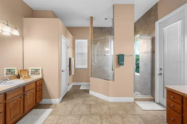 a bathroom with a double vanity sink a mirror and a shower