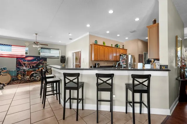 a kitchen with stainless steel appliances kitchen island granite countertop a refrigerator and a stove