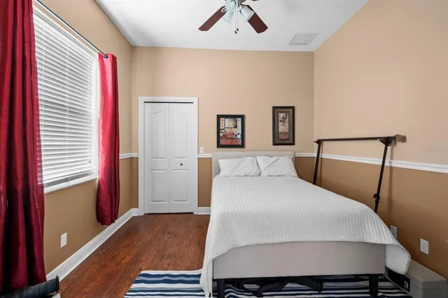 a bedroom with a bed and a large mirror