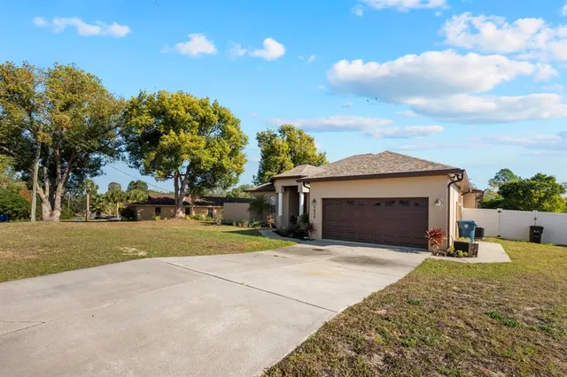 a view of a house with a yard and garage