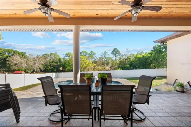 a view of a patio with table and chairs and potted plants