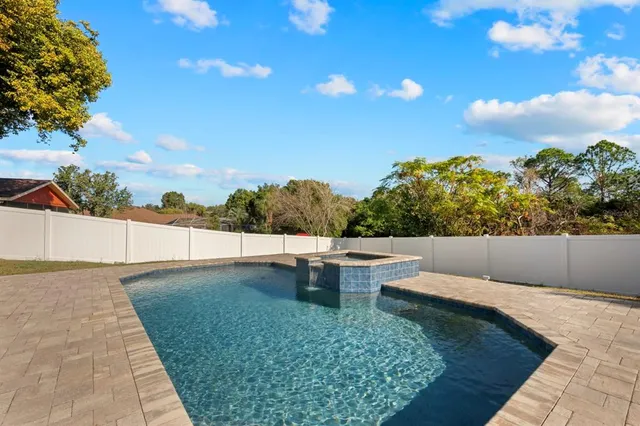 a view of a house with backyard and sitting area