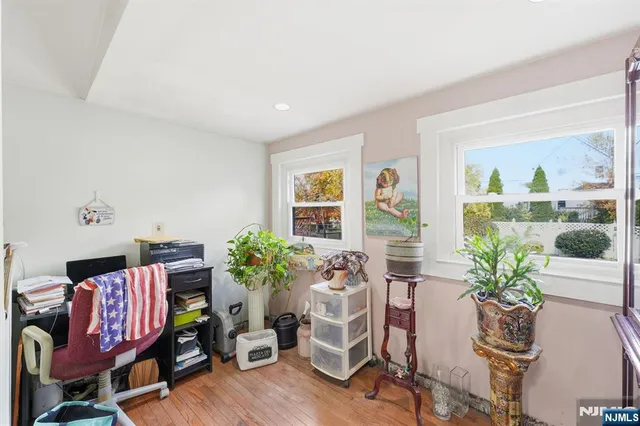 a living room with furniture flowerpot and wooden floor