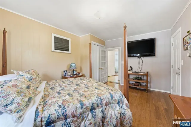 a bedroom with a bed and a flat screen tv