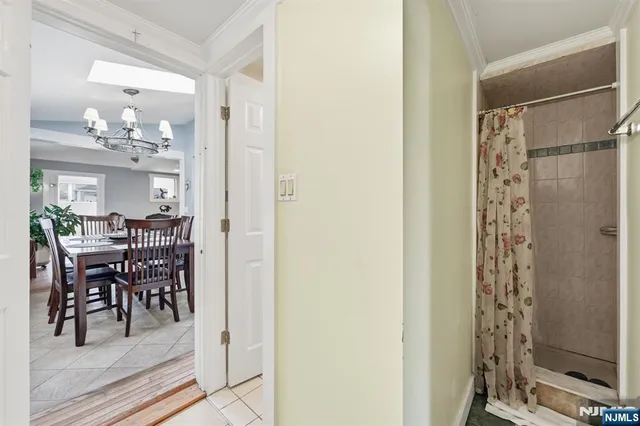 a view of a dining room with furniture and chandelier