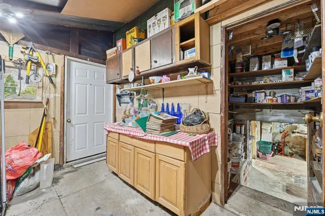 a utility room with stainless steel appliances lots of fruit and a window