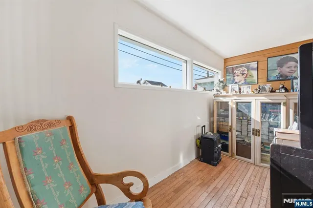 a view of a room with wooden floor and furniture