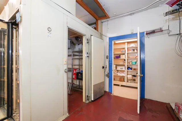 a living room with furniture and a shelf