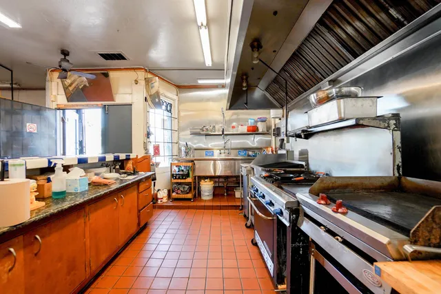 a kitchen with lots of appliances and a counter space