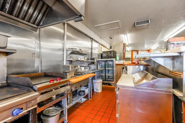 a kitchen with stainless steel appliances granite countertop a stove a sink and cabinets