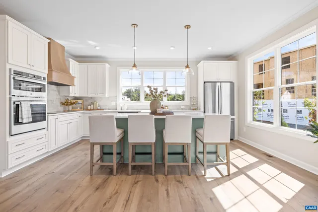 a kitchen with kitchen island granite countertop lots of counter top space and stainless steel appliances
