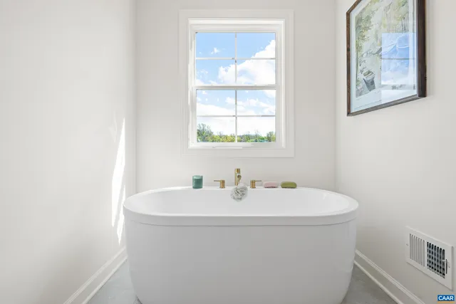 a spacious bedroom with a bed and a large window