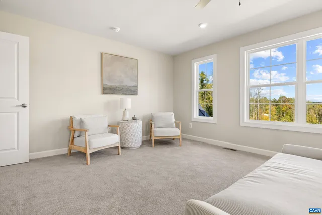 a bed sitting in a bedroom next to a window
