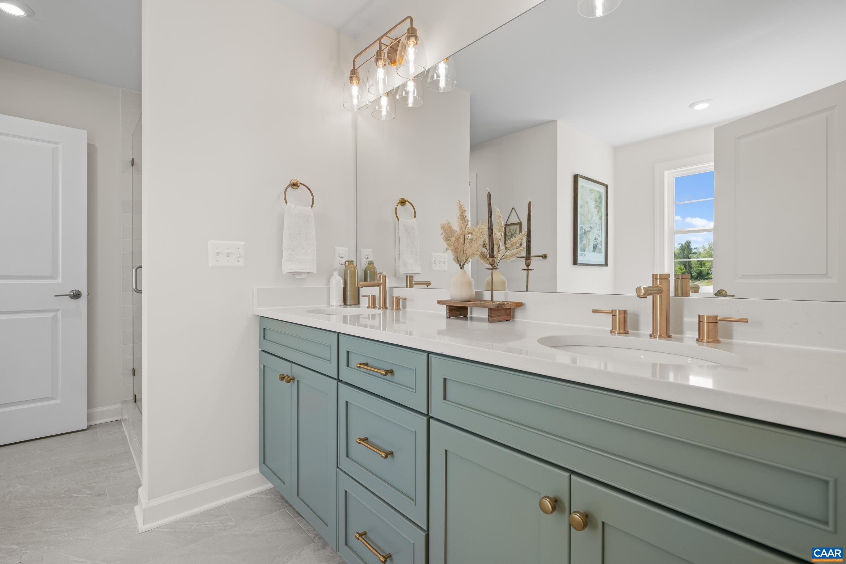 34 F Fowler Street Charlottesville, VA 22901 - Photo 39 of 68 a bathroom with double vanity sink a mirror and shower