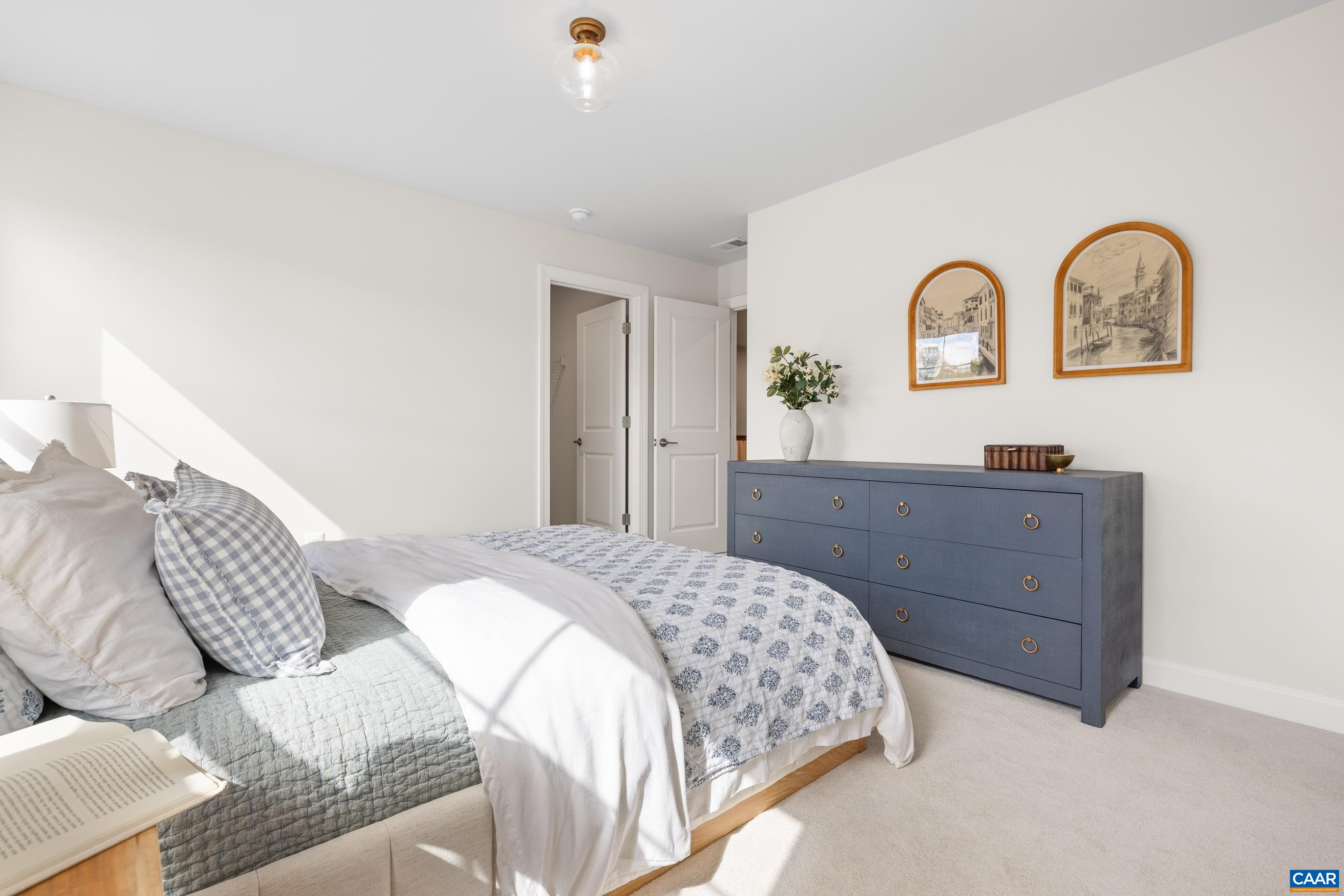 34 F Fowler Street Charlottesville, VA 22901 - Photo 42 of 68 a bedroom with a bed and a dresser