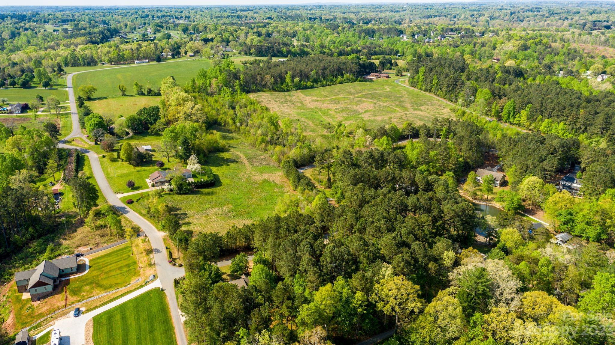 1341 Misty Lane, Unit 9 Hickory, NC 28601 - Photo 6 of 17 an aerial view of residential houses with outdoor space and trees